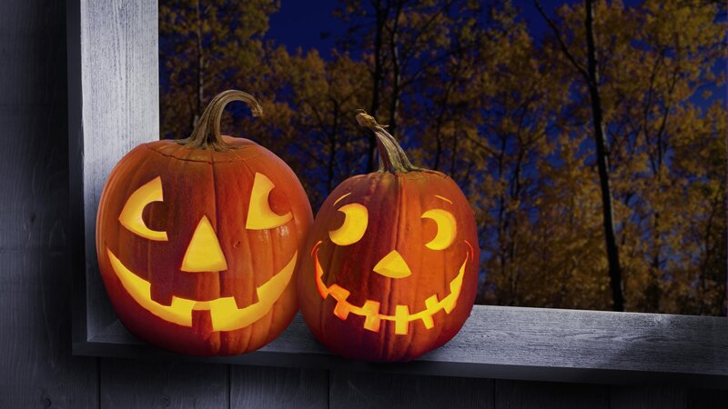 Two carved pumpkins at night