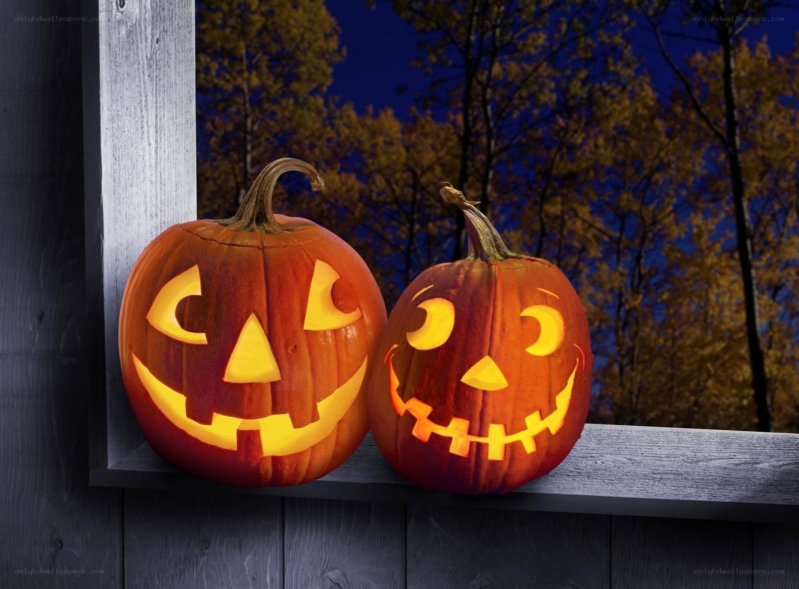 Two carved pumpkins at night