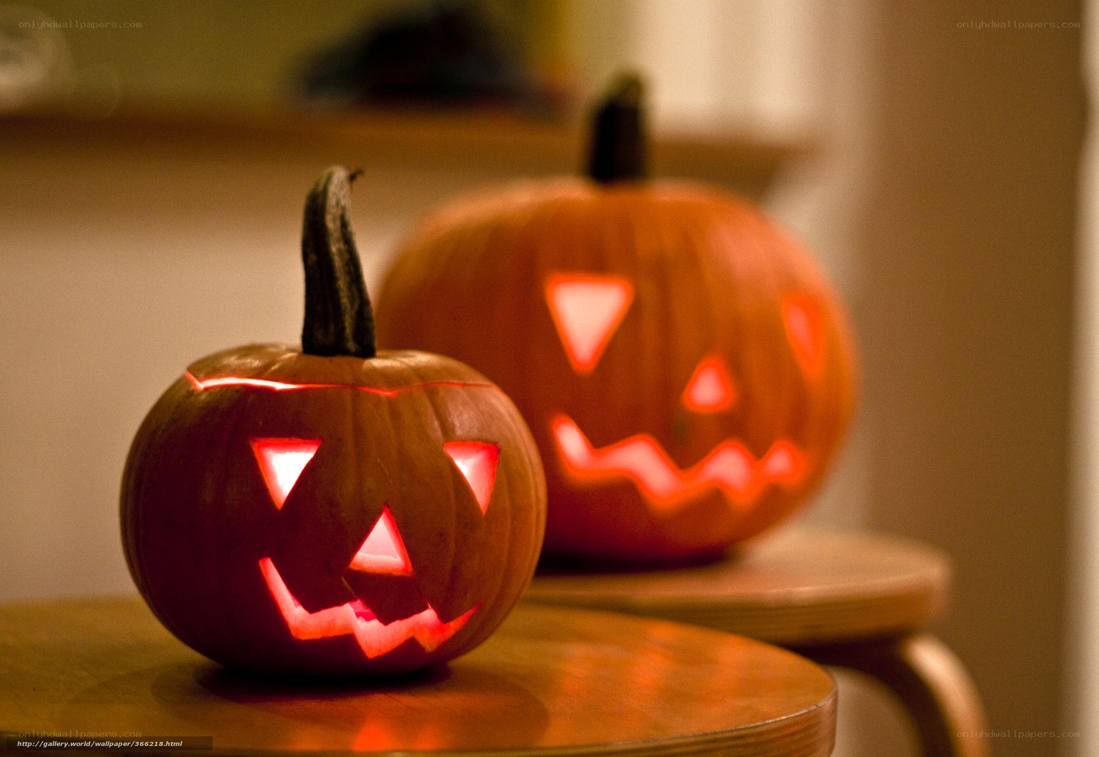 Two carved pumpkins on tables