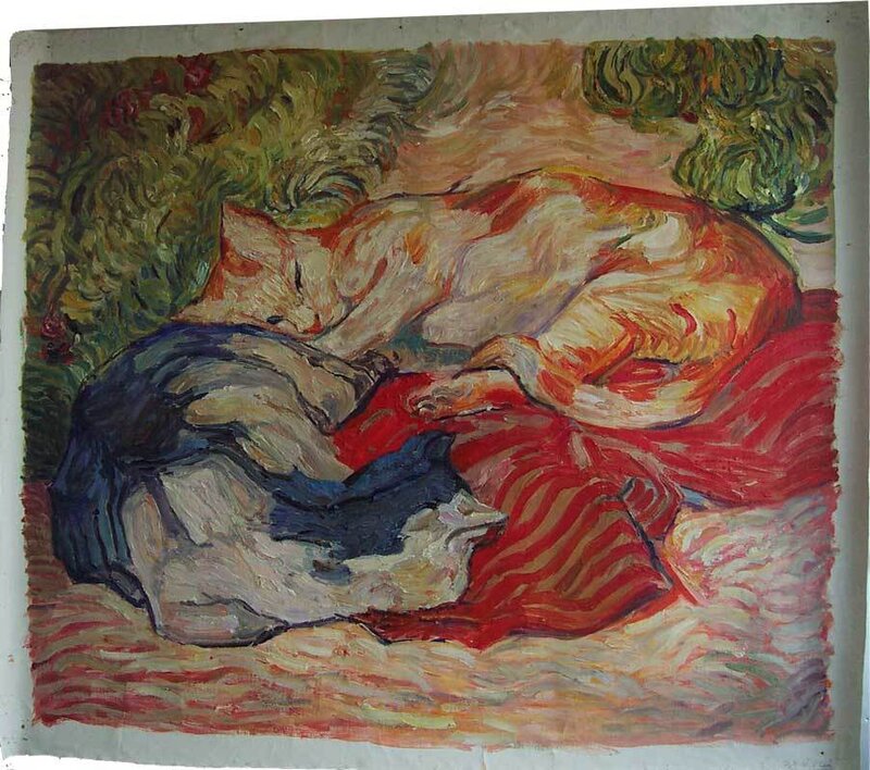 Two cats sleeping on a blanket