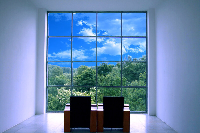 Two chairs facing a window