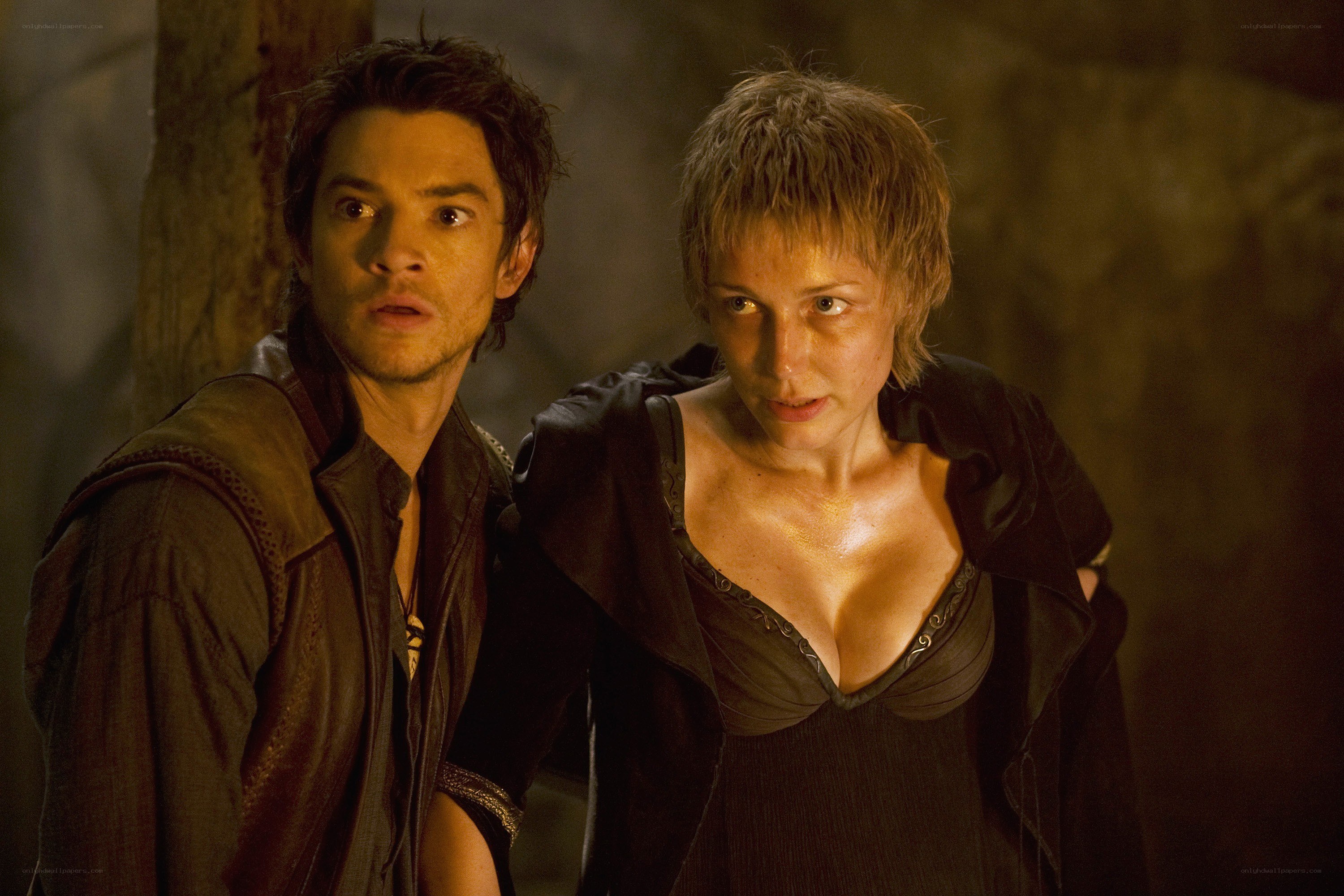 Two characters in a dimly lit scene