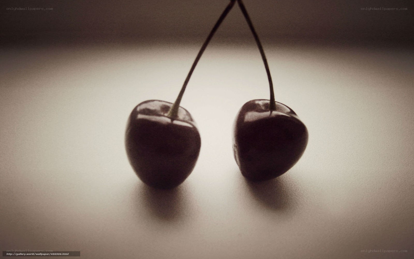 two cherries on a surface