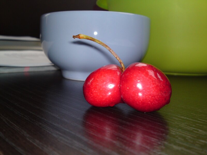 Two cherries on a table