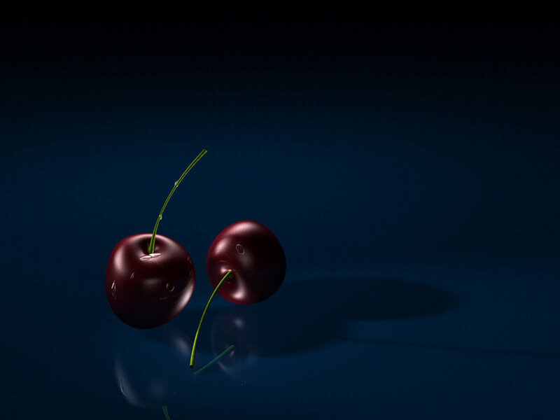 Two cherries on dark background
