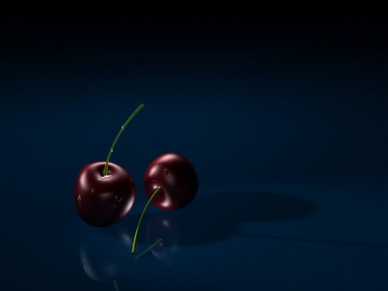 Two cherries on dark blue