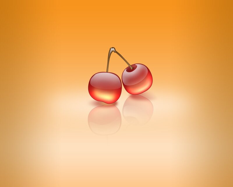 two cherries on orange background