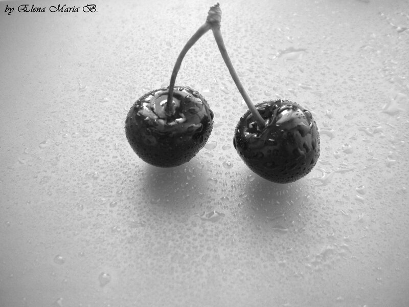 two cherries on wet surface