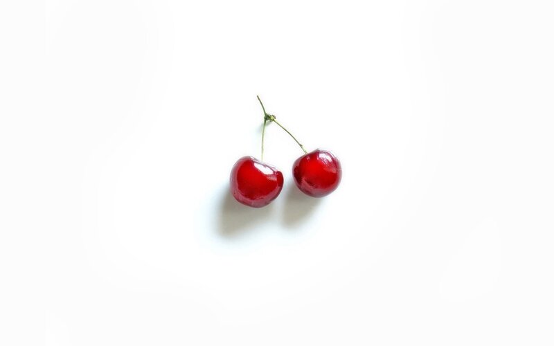 two cherries on white