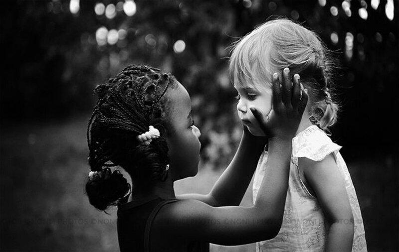 Two Children Holding Faces