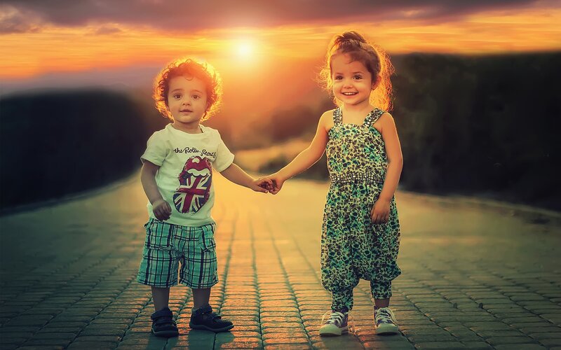 Two Children Holding Hands — Orange, Serene, Sunset, Photograph