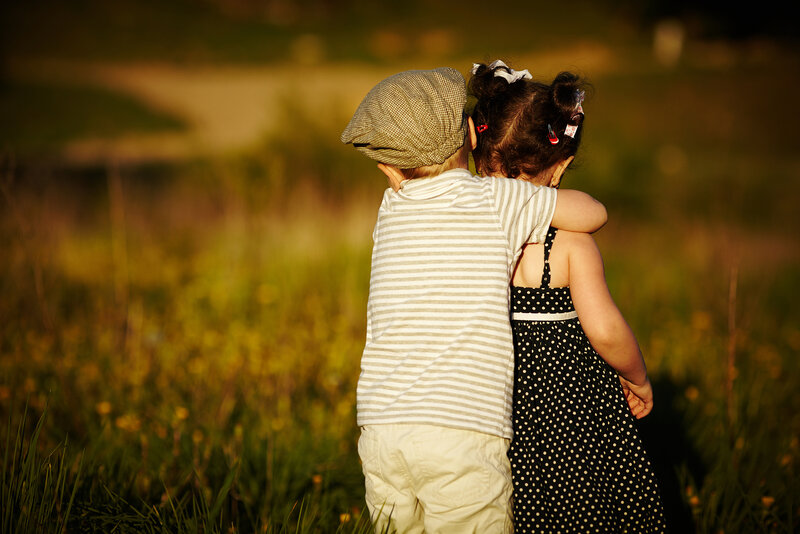 Two Children Hugging — Green, Serene, Sunset