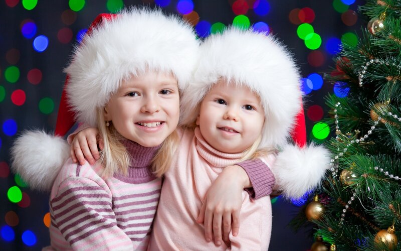 Two Children in Santa Hats — White, Festive