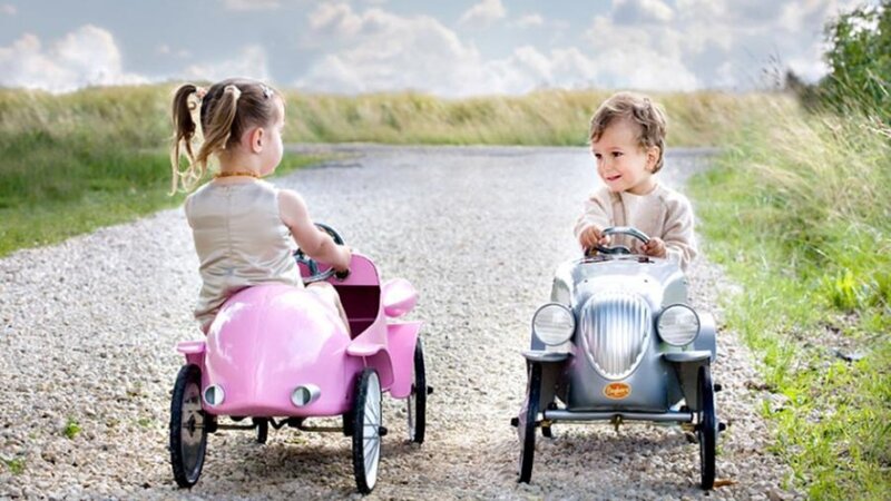 Two Children in Toy Cars