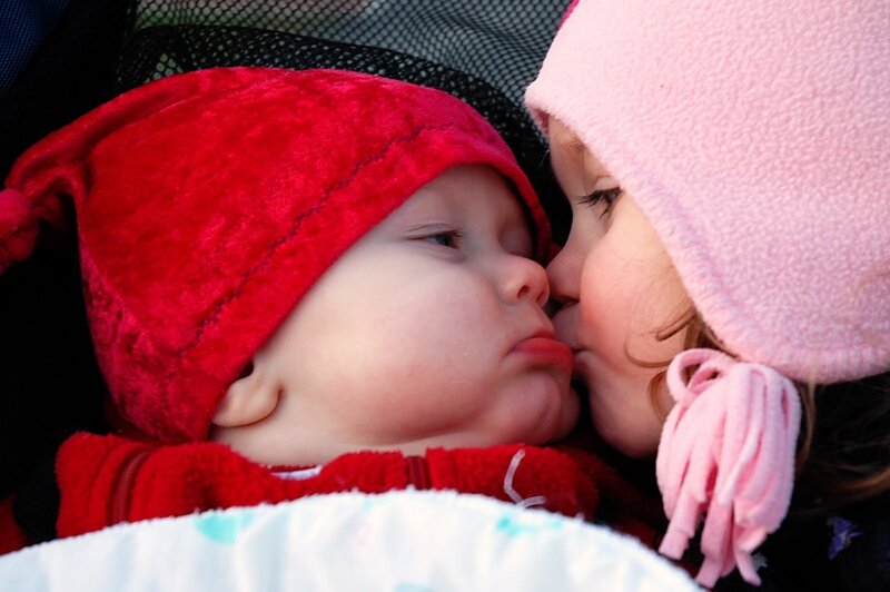 Two Children Kissing — Red, Tender, Winter