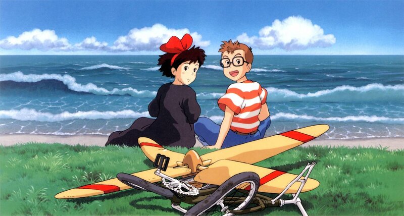 Two children on a beach with a glider