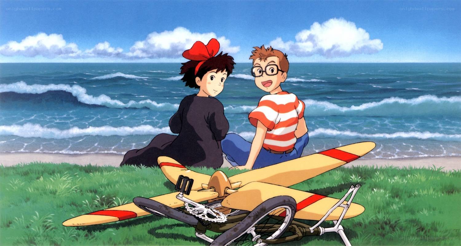 Two children on a beach with a glider