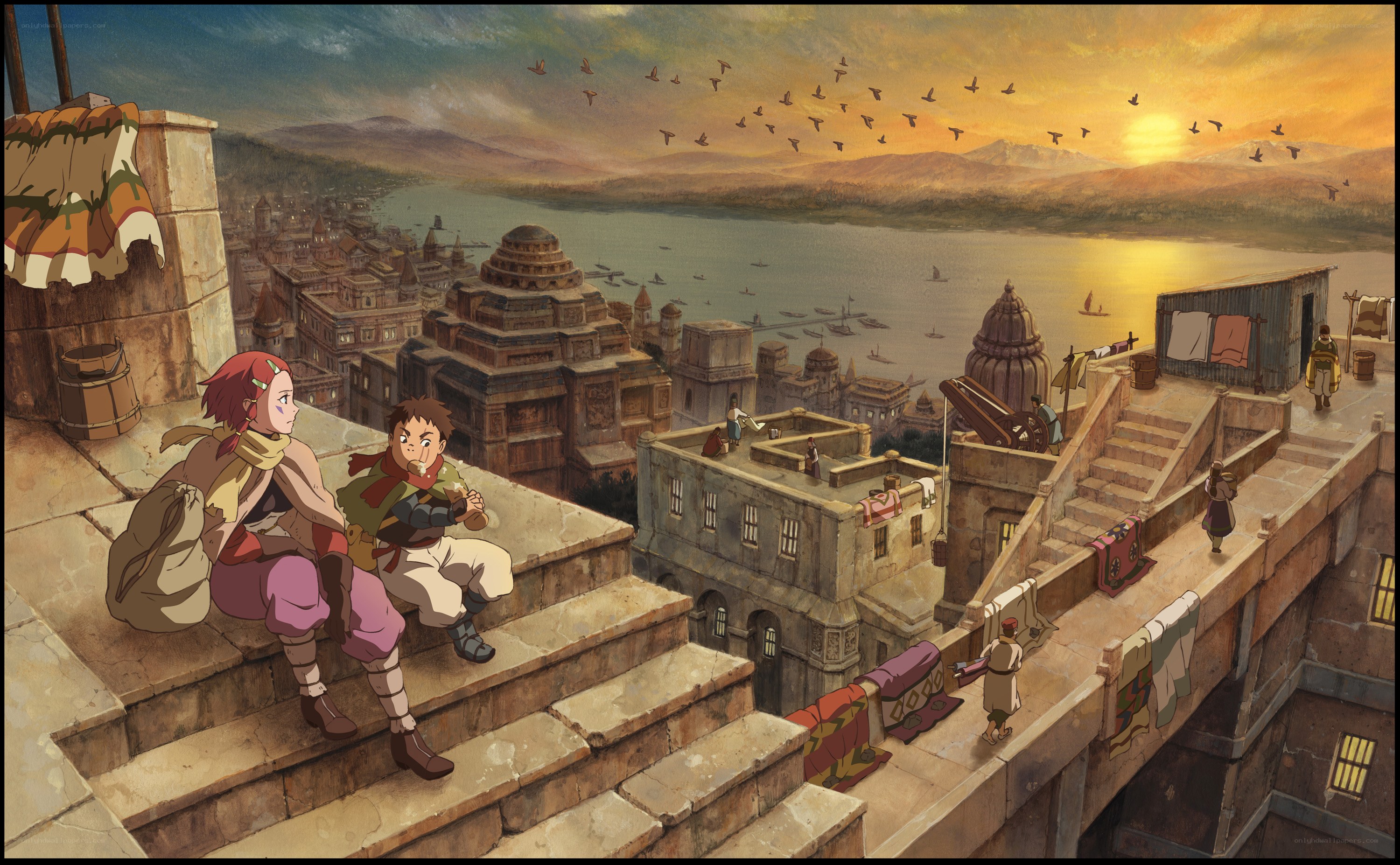 Two children on a rooftop at sunset