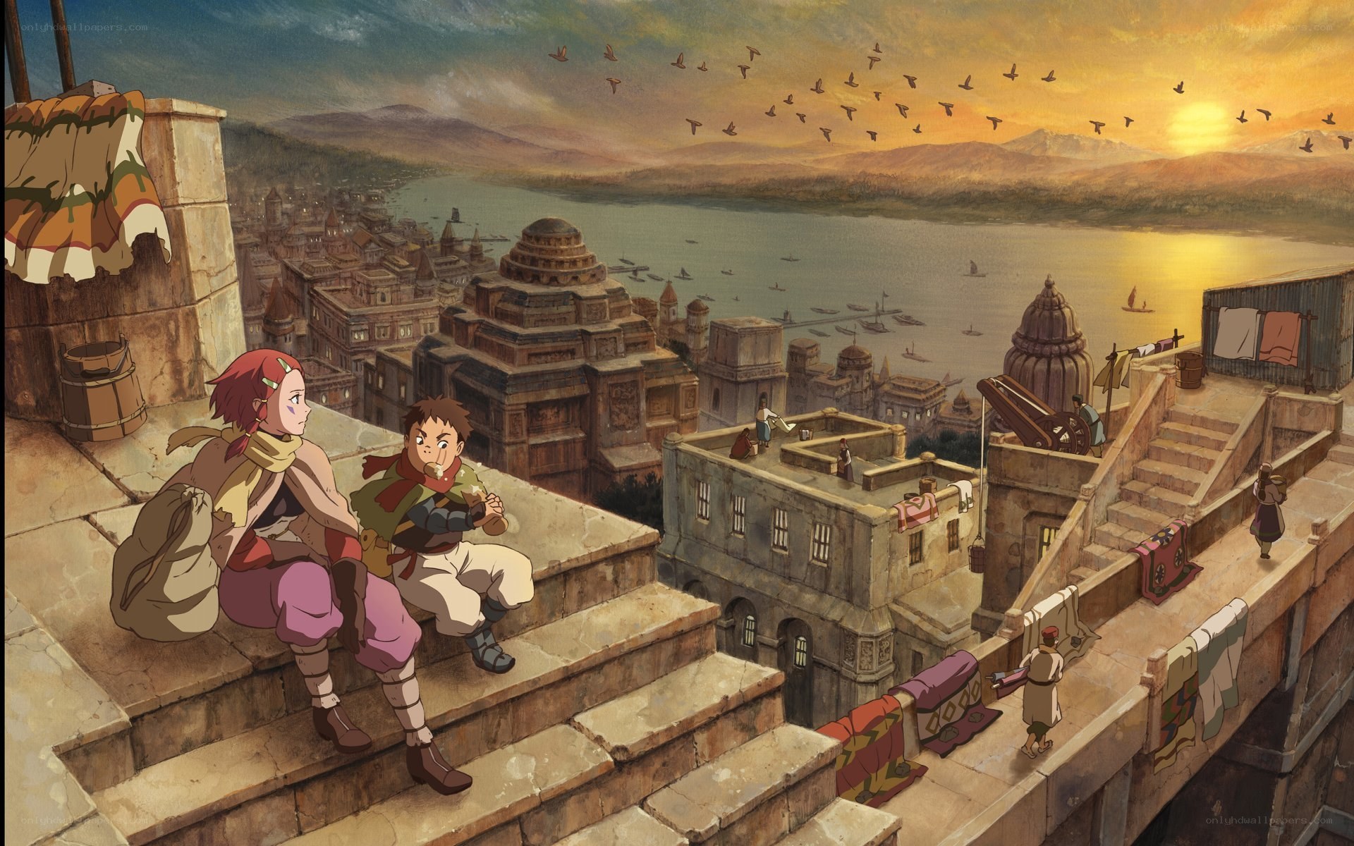 Two children on a rooftop at sunset