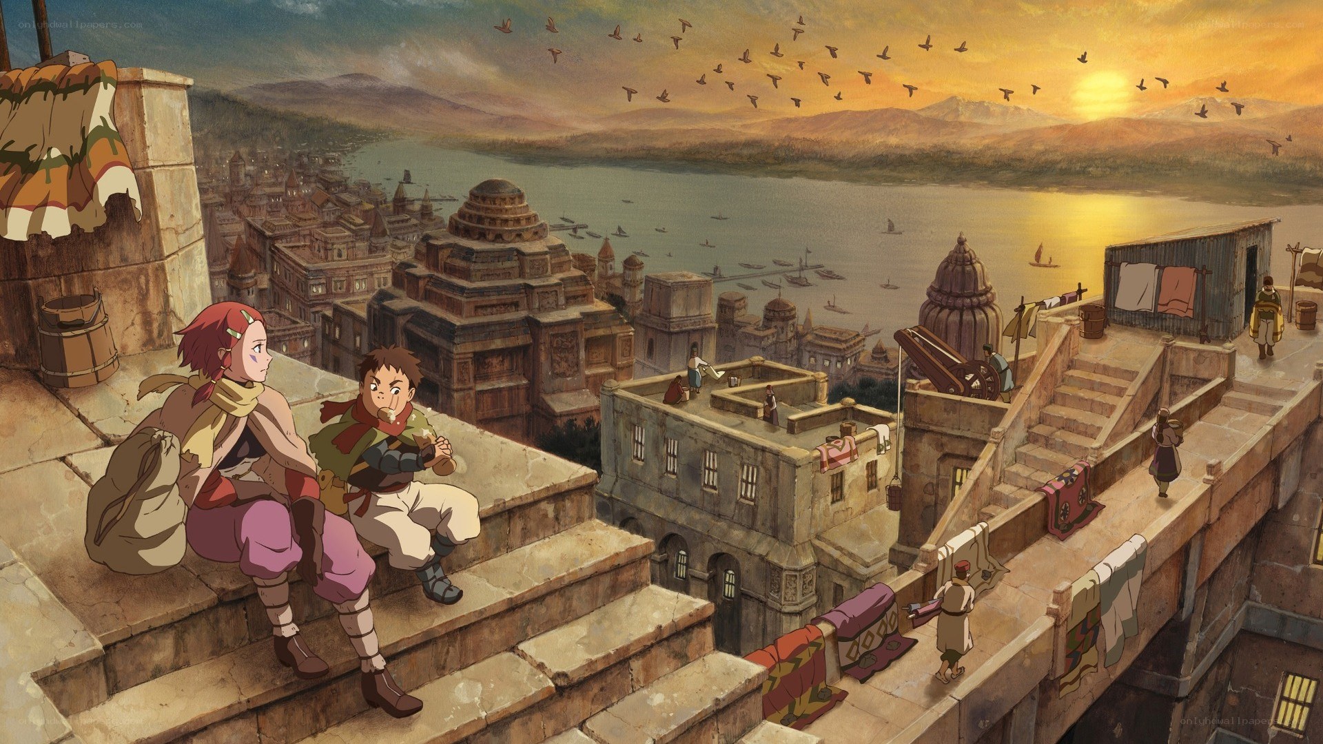 Two children on a rooftop at sunset
