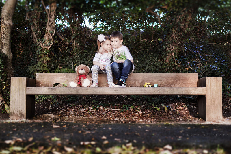 Two Children on Bench — Green, Serene, Afternoon