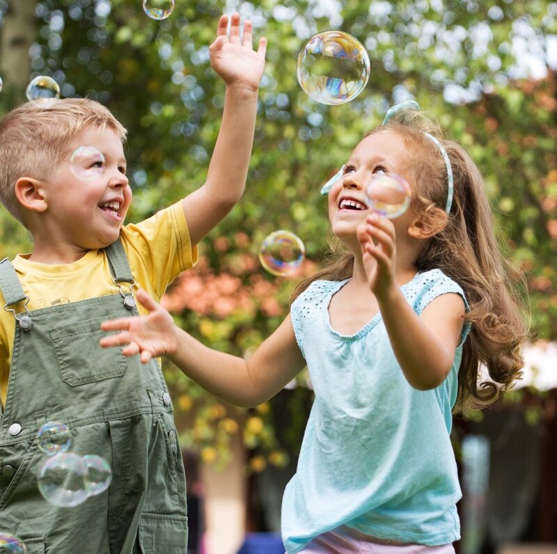 Two Children Playing with Bubbles