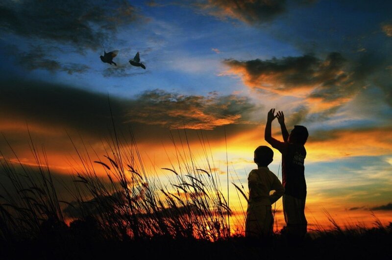 Two Children Silhouetted — Orange