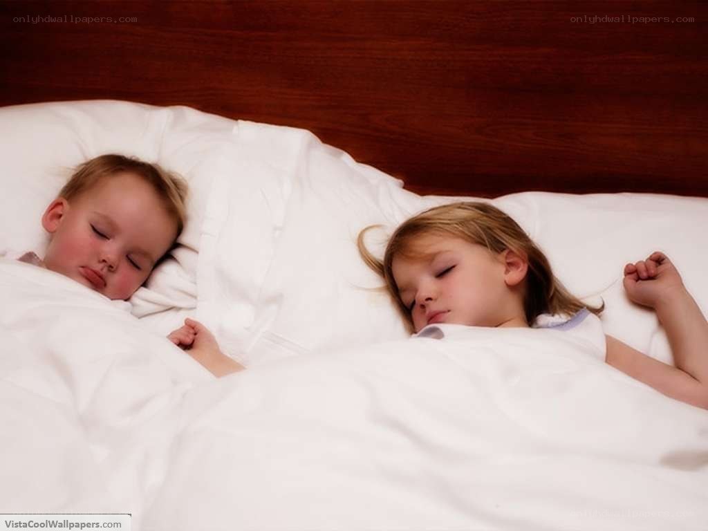 two children sleeping in bed