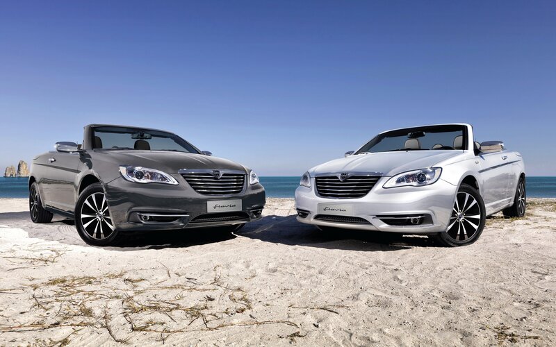 Two Chrysler convertibles on a beach