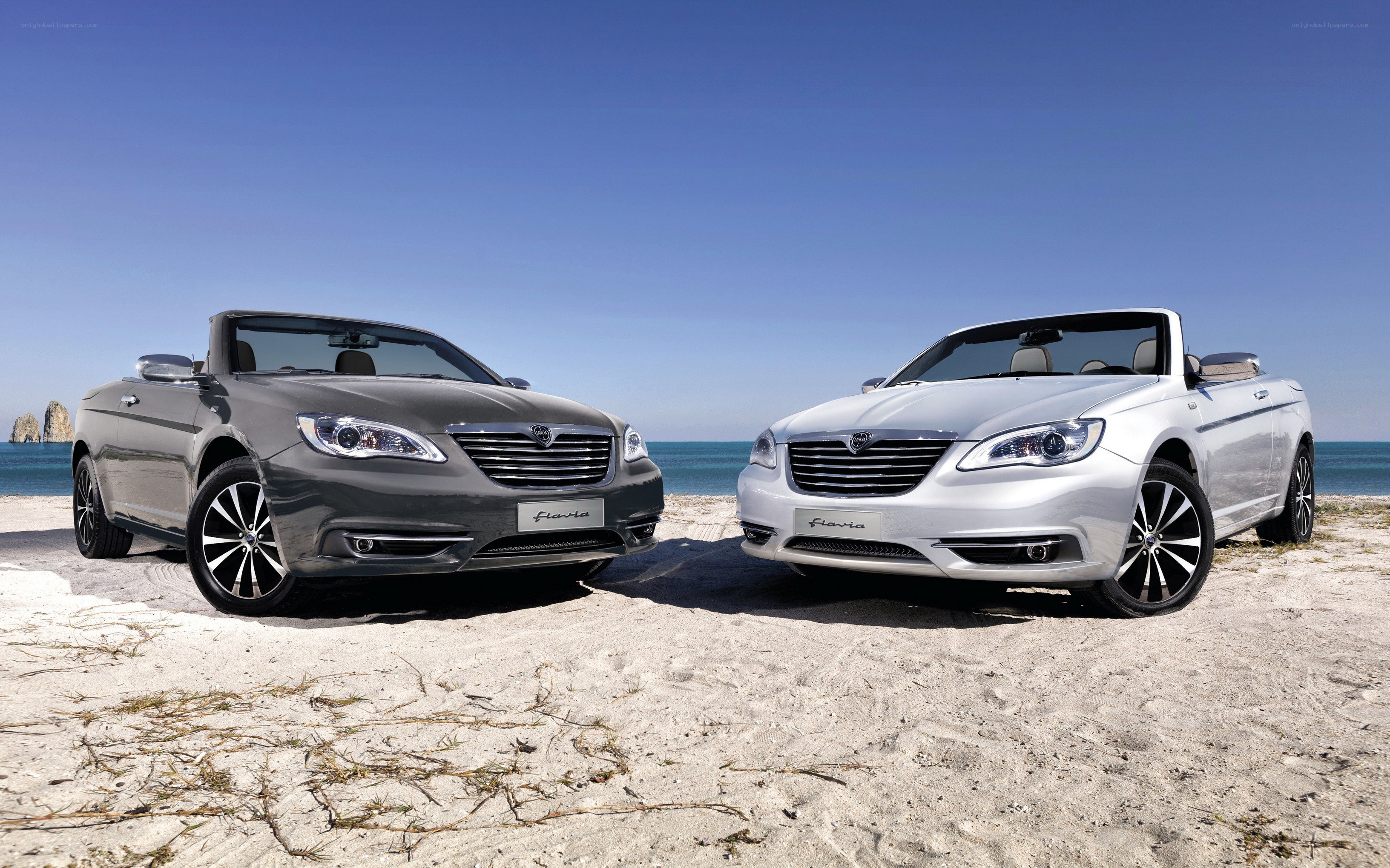 Two Chrysler convertibles on a beach