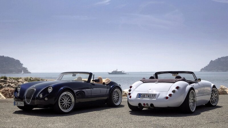 Two classic cars by the sea