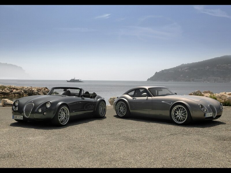 Two classic cars by the sea