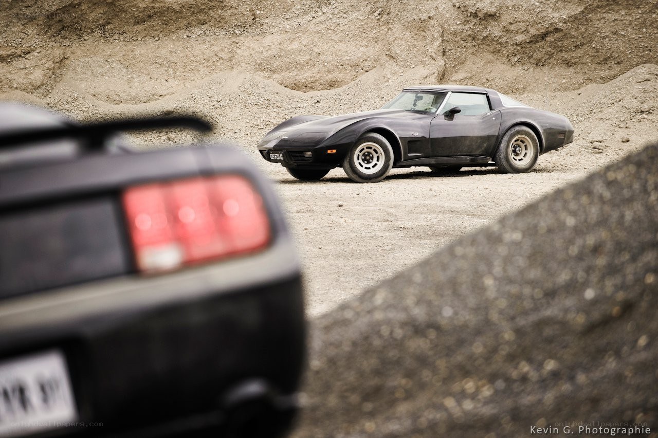 Two classic cars in a quarry