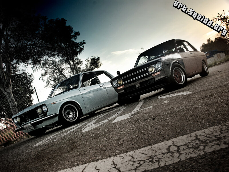 Two classic cars on asphalt