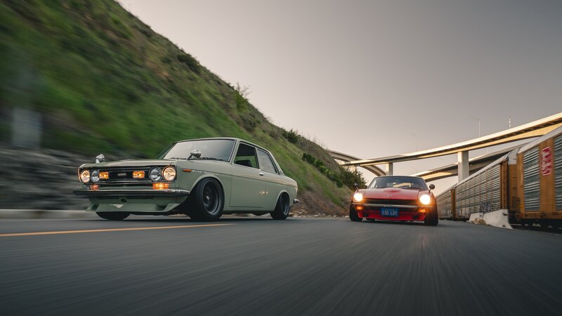 Two Classic Cars on Road — Green
