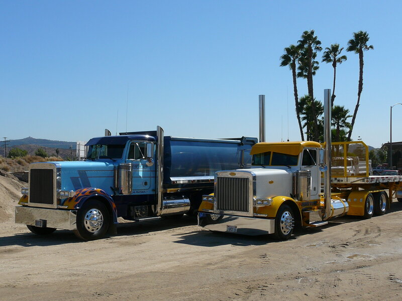 Two classic Peterbilt trucks parked