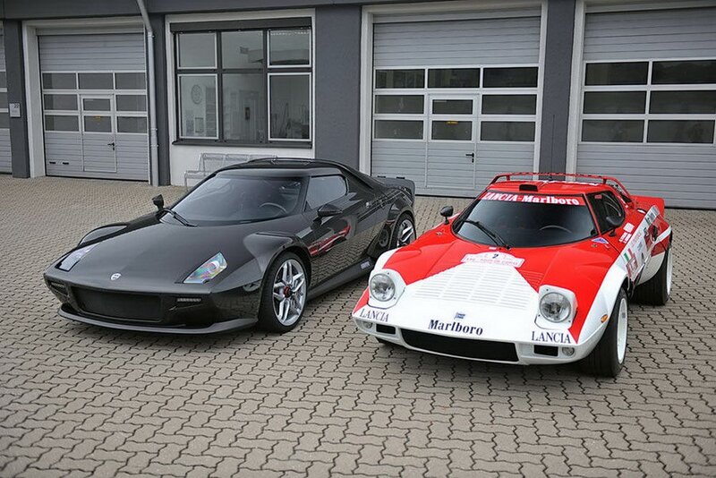 Two classic race cars parked