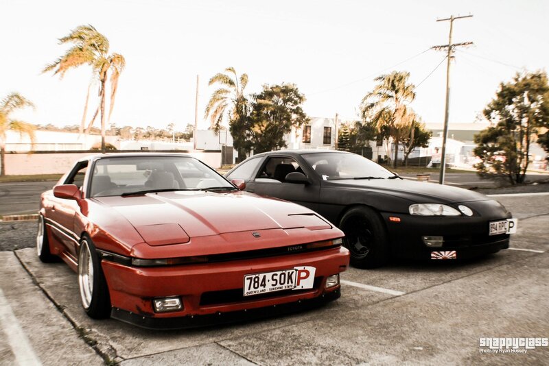 Two classic sports cars parked
