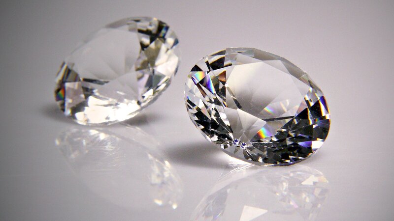 Two clear oval diamonds