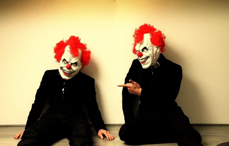 Two clowns in black suits