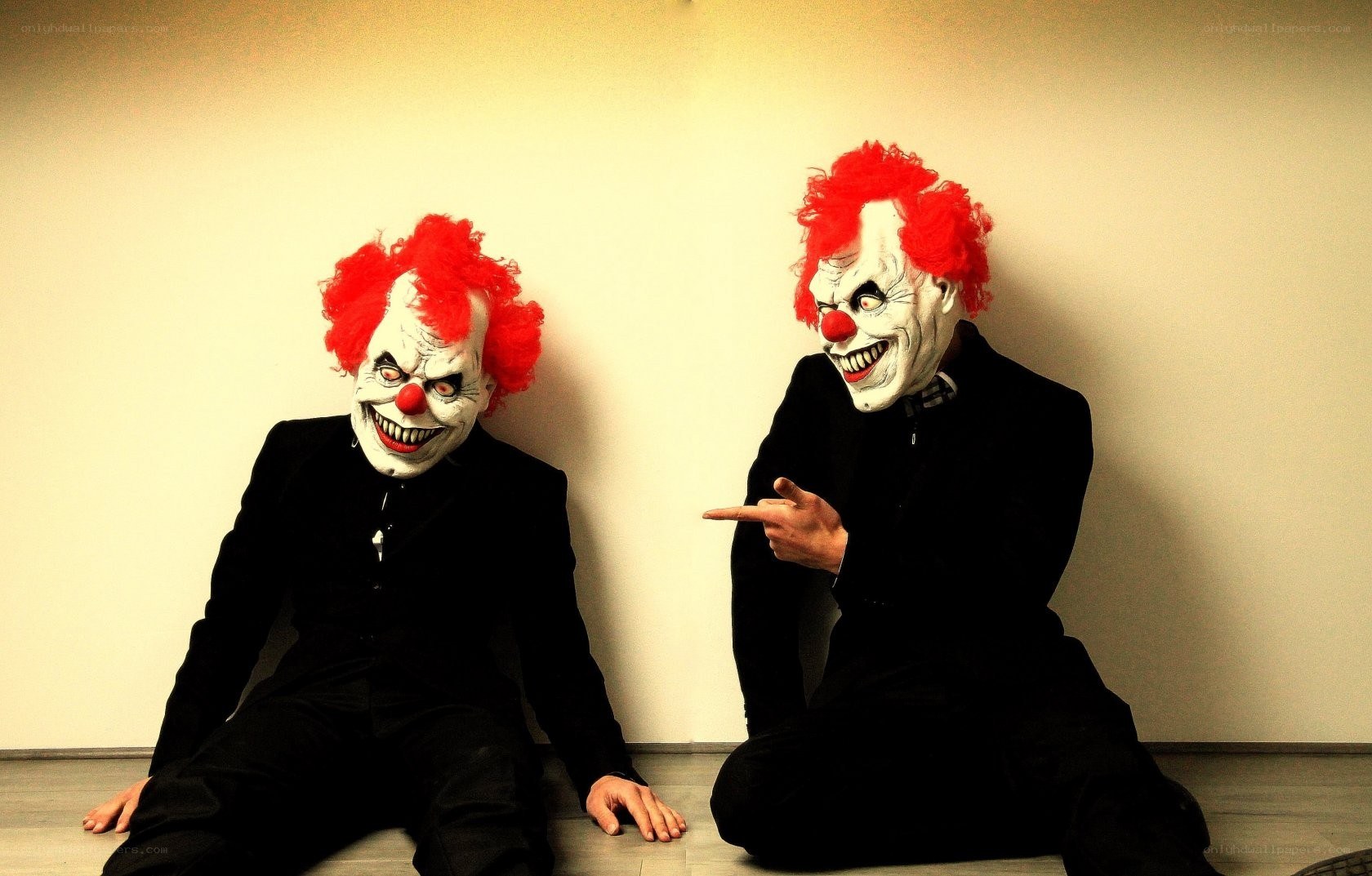 Two clowns in black suits