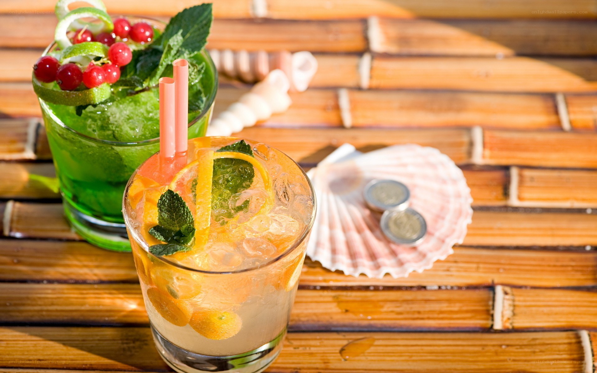 Two cocktails on a bamboo table