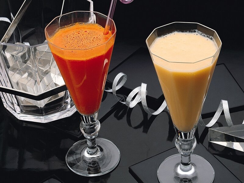 Two colorful drinks on black surface