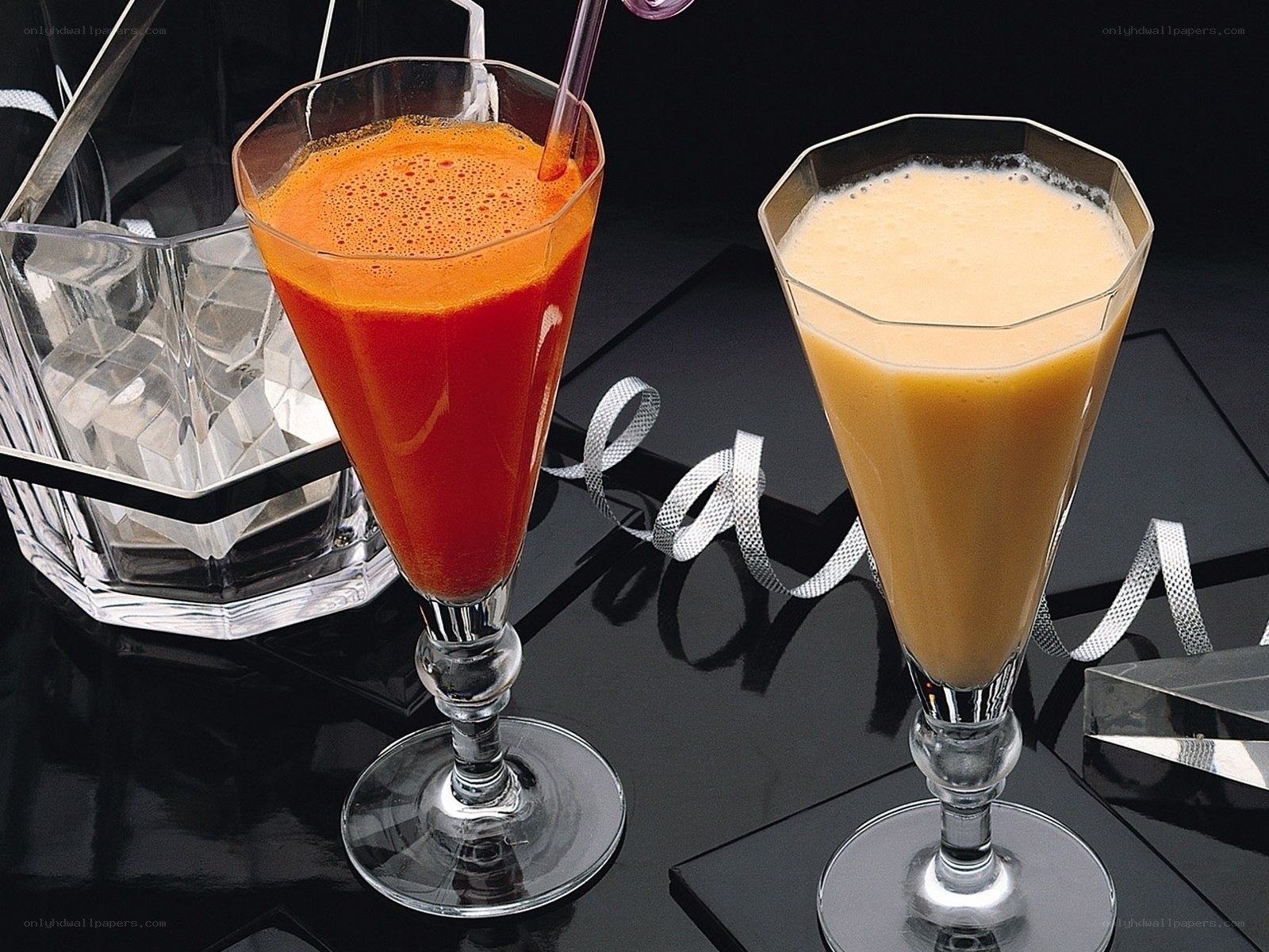Two colorful drinks on black surface