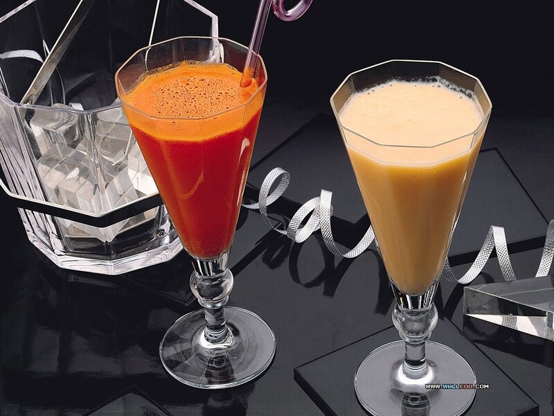 Two colorful drinks on black table