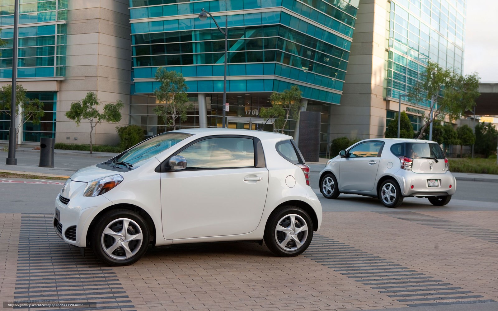 Two compact cars in a city