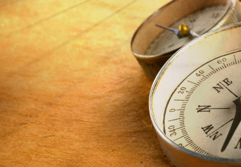 Two Compasses on Wood