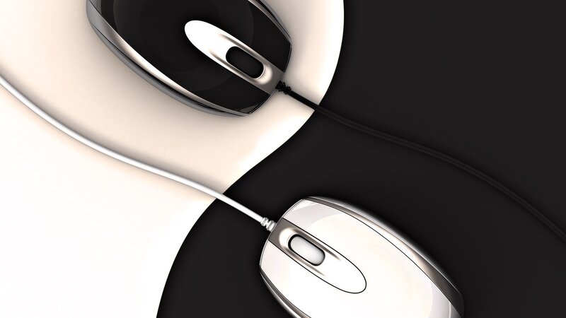Two computer mice on black and white surface
