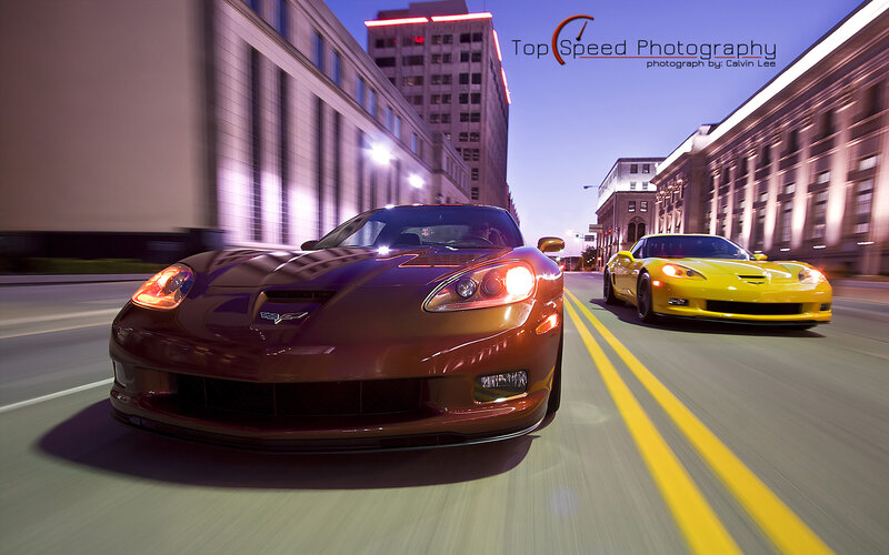 Two Corvettes racing at night