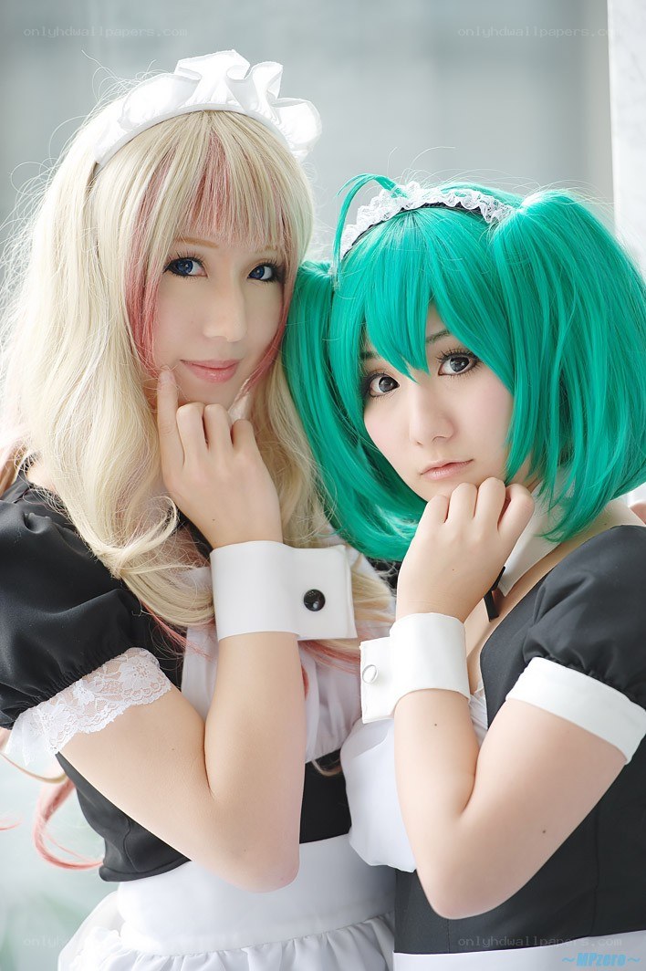 Two cosplayers in maid outfits